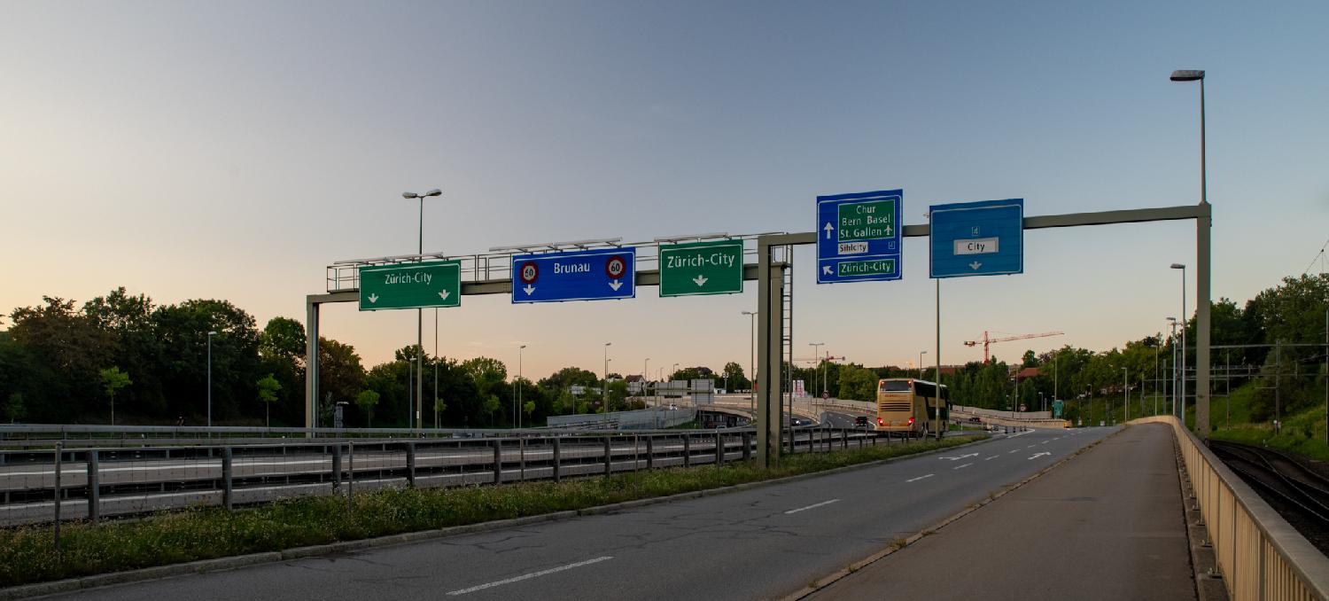 A3W in Zürich, seen from Allmendstrasse - a highway with multiple signs for Zürich-City, Brunau, Chur/Bern/Basel/St-Gallen.